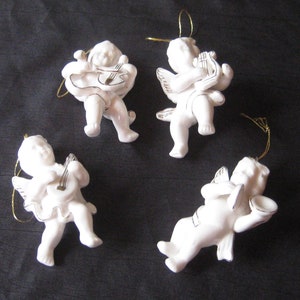 Vintage collection of ceramic cherub ornaments, white baby angels playing musical instruments, harp cymbals violin sitar, Christmas decor