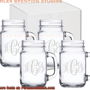 May include: Set of four clear glass mason jars with handles, each engraved with the monogram "HCS". The jars are packaged in a white box.