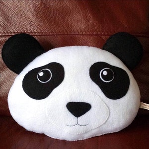 May include: A white plush panda head with black ears, eyes, nose, and markings. The panda has a stitched smile.