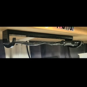 Under shelf wand holder