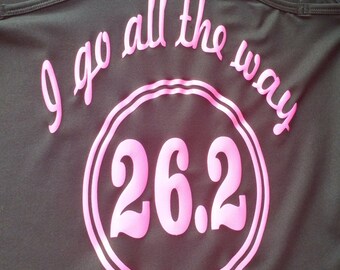 May include: Black tank top with pink lettering that says "I go all the way 26.2" in a circle.
