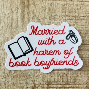 May include: A white sticker with red cursive text that reads "Married with a harem of book boyfriends." The sticker features a black and white illustration of an open book and a ring with a diamond.