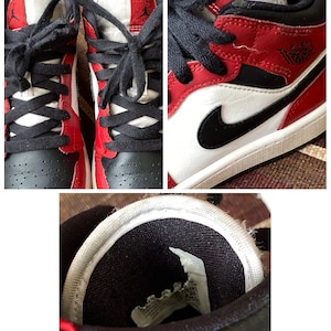 May include: Red and black leather sneakers with white accents and black laces. The sneakers have a white sole and a black swoosh logo on the side.