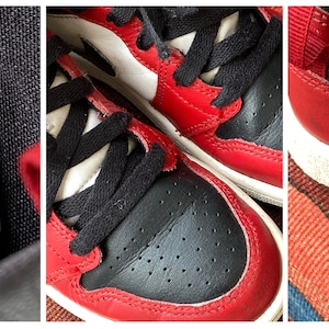 May include: Red and black children's sneakers with white accents. The size tag reads US 1Y, UK 13.5, EUR 32, cm 20, BR 31, CN 200(2.5), 640734-069, 12/04/19 02/29/20, UPC 00193658126326, 0113T3MGB25, MADE IN INDONESIA, HECHO EN INDONESIA, FABRIQUE EN INDONESIE, FARIFICADO NA INDONESIA, www.