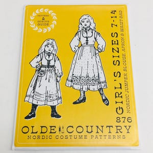 May include: A yellow sewing pattern envelope for a Nordic costume, featuring illustrations of two figures in jumpers, blouses, aprons, and waist bags. Text includes "Pattern & Sewing Guide," "Girl's Sizes 7-14," "876," and "Olde Country Nordic Costume Patterns."