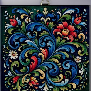 May include: Square wall art featuring a vibrant floral design. The artwork showcases a dark background with a detailed pattern of blue, red, yellow, and green stylized flowers and leaves. A gold triangle is attached to the top for hanging.