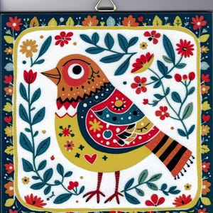May include: A square decorative wall plaque featuring a stylized bird with a yellow body, orange head, and patterned wings in red, blue, and white. The bird is surrounded by a border of colorful flowers and leaves on a white background.