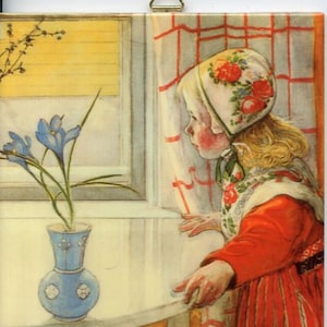 May include: A square ceramic tile featuring a vintage illustration of a young child looking out a window. The child wears a floral bonnet and red dress. A blue vase with flowers sits on the windowsill. The window has yellow blinds and red-checkered curtains.