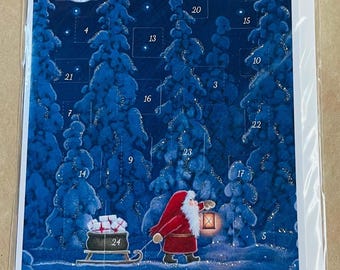 May include: A rectangular advent calendar card featuring a dark blue winter forest scene with a crescent moon and stars. Santa Claus in a red coat pulls a sleigh filled with white gifts. The card includes twenty-four numbered perforated doors.