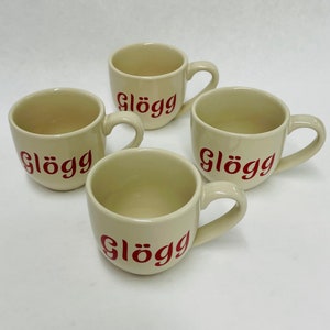 May include: A set of three ceramic mugs with a speckled, matte finish. The mugs are in shades of cream, light gray, and dark gray. Each mug has a simple, minimalist design, perfect for coffee or tea.