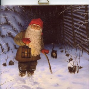 May include: A square decorative wall tile featuring a painted scene of a bearded figure in a red hat and brown coat holding a lit lantern and a wooden staff in a snowy landscape with a small black and white cat walking nearby at night.