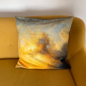 May include: A yellow sofa with a cushion featuring a painting of a cloudy sky with shades of blue, yellow, and orange.