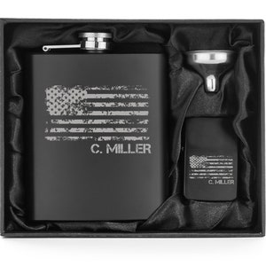 May include: A black flask and lighter set with an American flag design and the name "C. MILLER" engraved. The set includes a silver funnel, all presented in a black gift box.
