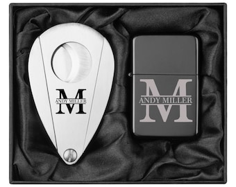 May include: A black gift box with a silver cigar cutter and a black lighter. Both items have the initials "M" and the name "Andy Miller" engraved on them.