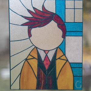 May include: A stained glass window panel featuring a person with red hair wearing a yellow jacket, a dark suit, and a red tie. The background is a silver and blue geometric pattern.