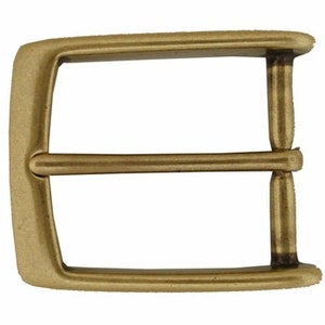 May include: A gold-toned metal belt buckle with a rectangular shape and a double prong design.