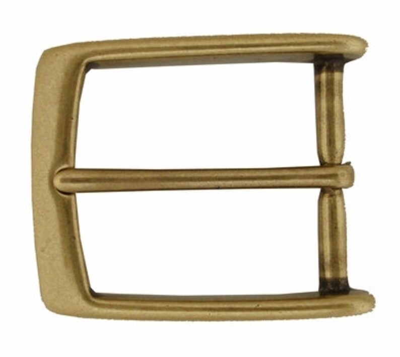 May include: A gold-toned metal belt buckle with a rectangular shape and a double prong design.