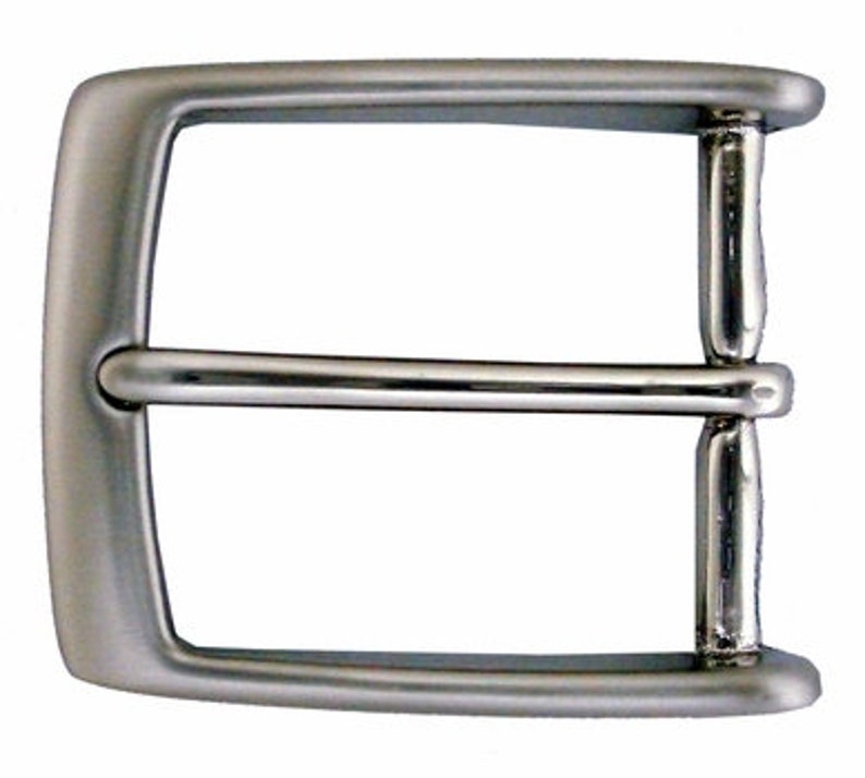 May include: A silver metal belt buckle with a smooth, rounded finish.