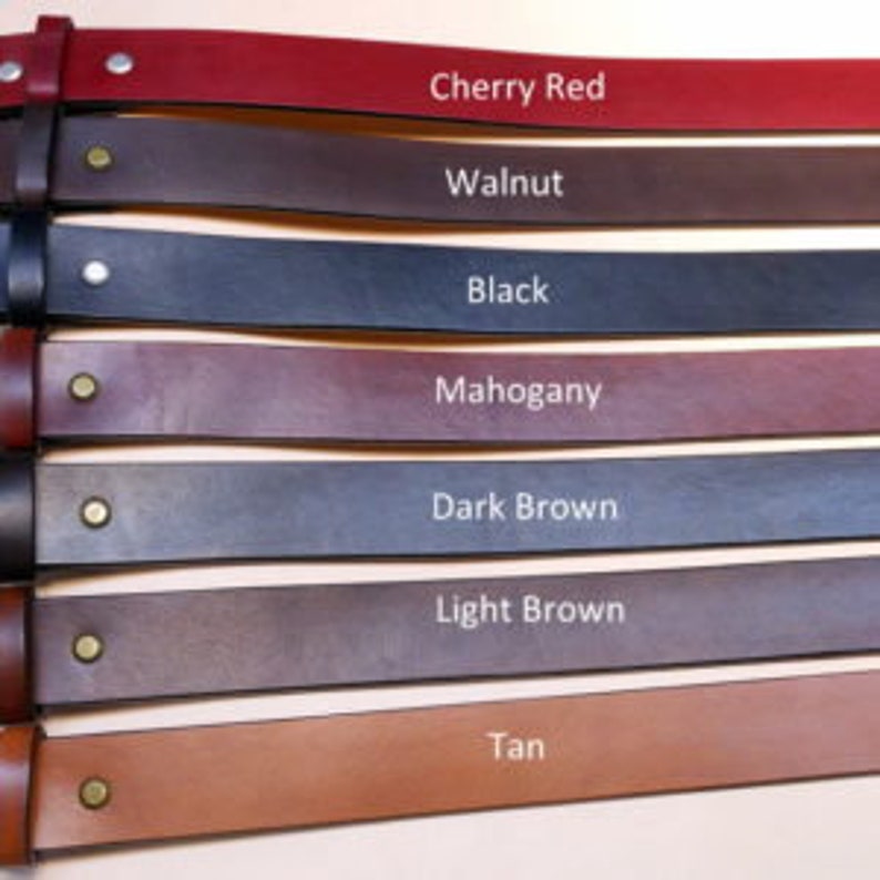 May include: Seven leather belts in various colors, including tan, light brown, dark brown, mahogany, black, walnut, and cherry red.