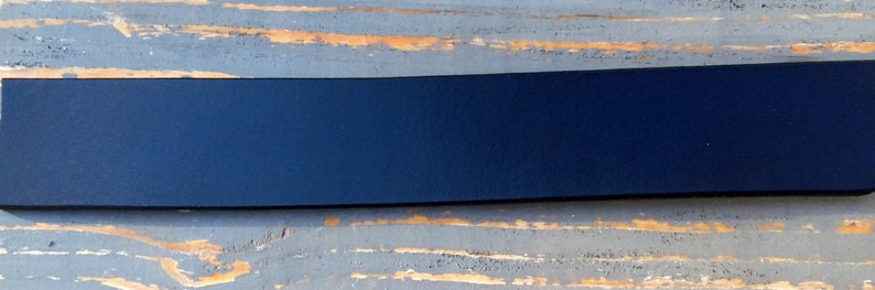 May include: A dark blue, rectangular, flat, smooth, and solid piece of material.