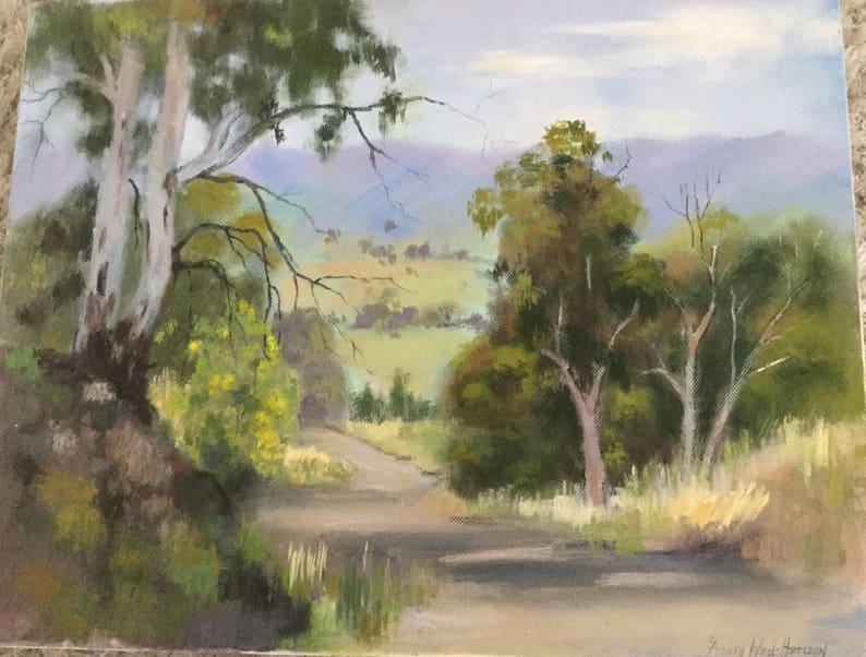 May include: A painting depicting a landscape with a winding dirt road leading into a valley. The road is flanked by trees, including a tall, white-barked tree on the left of the image. The valley is filled with green grass and trees, and the sky is a soft blue.