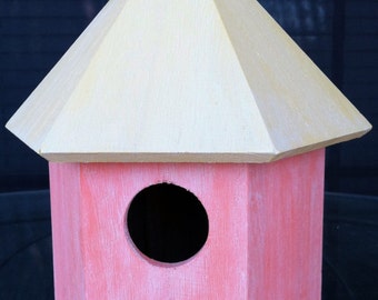 Antiqued birdhouse in yellow and orange with leaves charm.