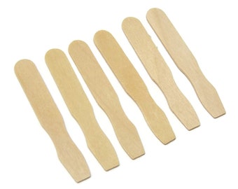 May include: Seven wooden craft sticks, also known as popsicle sticks, are arranged in a row on a white background. The sticks are all the same size and shape, and they are made of natural wood.