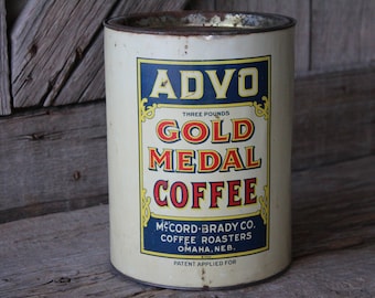 May include: Vintage tin can for Advo Gold Medal Coffee, a three-pound container from McCord-Brady Co. Coffee Roasters in Omaha, Nebraska. The can is white with blue, red, and yellow lettering.