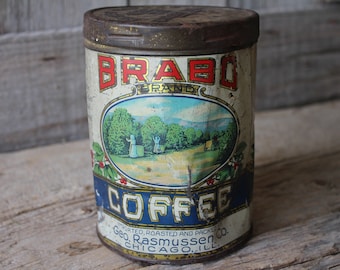 May include: Vintage Brabo Brand Coffee tin with a faded image of a coffee plantation and the text "IMPORTED, ROASTED AND PACKED Geo. Rasmussen Co. CHICAGO, ILL."