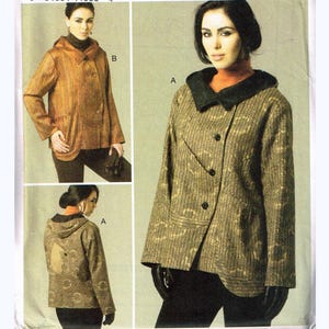May include: A sewing pattern envelope with the text "V8752" and "MARCI TILTON". The envelope features images of a hooded jacket in various views. The jacket is a mix of brown and green tones.