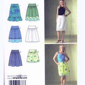 May include: Simplicity pattern 4185 for skirts, showing different skirt designs. The image includes illustrations of the skirt styles and size details. Two women are shown wearing skirts made from the pattern. The pattern size is K5, with sizes 8, 10, 12, 14, and 16.