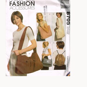 May include: A sewing pattern for four different bags. The pattern is called McCall's Fashion Accessories and the pattern number is 8705. The bags include a tote bag, a hobo bag, a shoulder bag, and a backpack.
