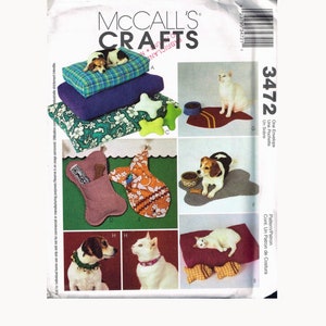 May include: McCall's Crafts sewing pattern number 3472 for making pet beds and accessories. The pattern includes instructions for making a dog bed, a cat bed, a dog bone toy, a cat toy, and a food bowl mat. The pattern is illustrated with photos of the finished products.