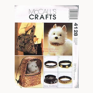 May include: McCall's Crafts pattern for pet accessories. The image shows a pet carrier, collars, and a pet carrier backpack. A cat is in a patterned carrier, and a dog wears a gold chain collar. Measurements are not included.