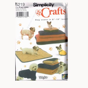 May include: Simplicity Crafts sewing pattern for dog coats and beds. The pattern includes instructions for making coats in sizes 8 to 18 inches and beds in various sizes. The pattern is illustrated with photos of dogs wearing the coats and using the beds.