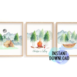 May include: Set of three framed watercolor prints featuring camping scenes. Each print depicts a different outdoor scene: a tent, a campfire with the text "Adventure is Calling", and a boat. The prints have a light wood frame and are perfect for a nursery or kids room.