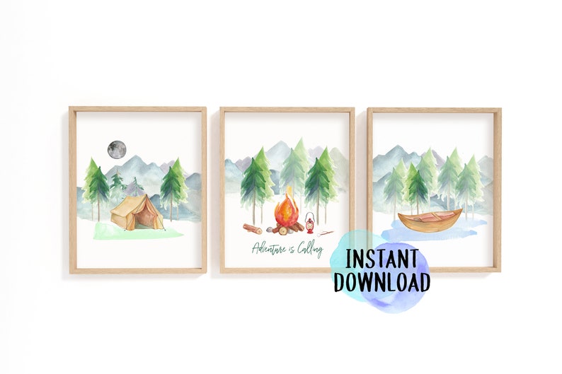 May include: Set of three framed watercolor prints featuring camping scenes. Each print depicts a different outdoor scene: a tent, a campfire with the text "Adventure is Calling", and a boat. The prints have a light wood frame and are perfect for a nursery or kids room.