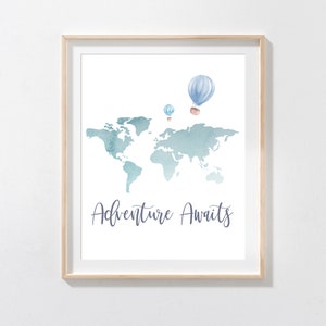 May include: A framed print featuring a watercolor world map in shades of blue and teal. Above the map are three hot air balloons. The words "Adventure Awaits" are written in a script font below the map.