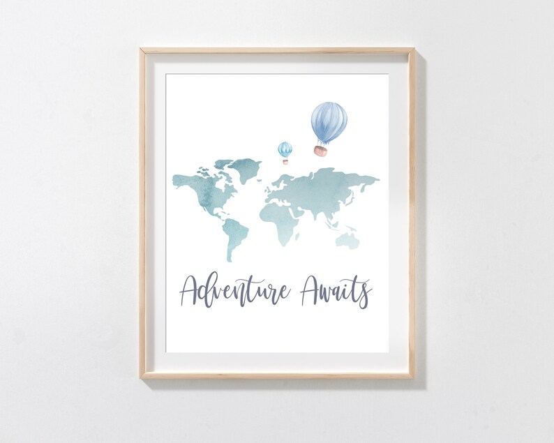 May include: A framed print featuring a watercolor world map in shades of blue and teal. Above the map are three hot air balloons. The words "Adventure Awaits" are written in a script font below the map.