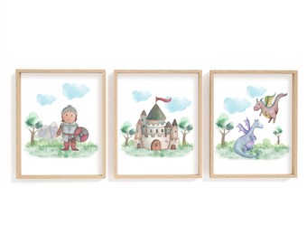 May include: Set of three framed watercolor prints featuring a knight, a castle, and two dragons. The knight is in armor, holding a shield. The castle has a red flag. The dragons are purple and pink, with green wings. The artwork is set against a green landscape.