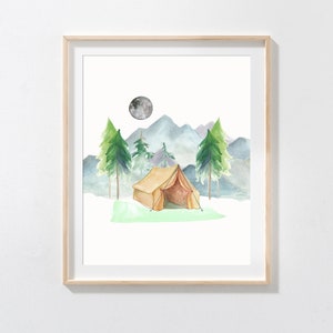 May include: Watercolor painting of a camping scene. A tan tent sits on green grass, with green trees and blue mountains in the background. A gray moon is in the sky. The artwork is framed in a light wood frame.