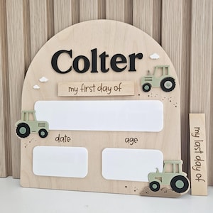 May include: An arched wooden sign featuring the name Colter in black, with the text my first day of, date, and age. It includes three light green tractor cutouts, small white clouds, and a separate wooden piece reading my last day of.
