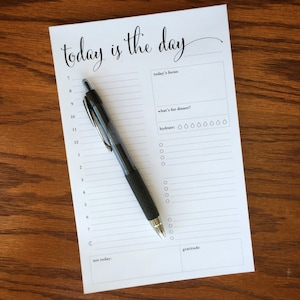 May include: A printable daily planner with the text "today is the day" at the top. The planner includes sections for today's focus, what's for dinner, hydrate, not today, and gratitude.