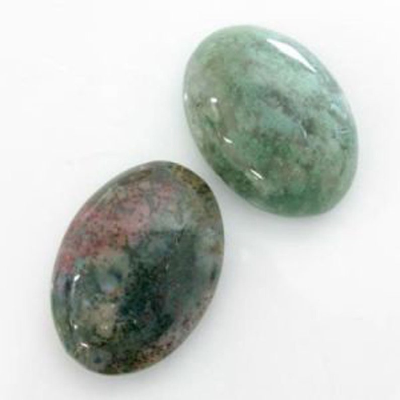 May include: Two oval-shaped green and brown agate stones. The stones have a mottled pattern and are smooth and polished.