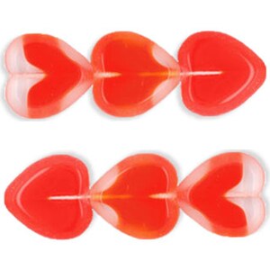 May include: Six red and white heart-shaped beads. The beads are translucent and have a glossy finish.