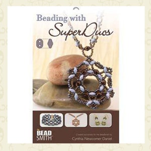 May include: Beading with Super Duos book cover featuring a necklace with a brown and blue beaded pendant, a bracelet, earrings, and the text "Beading with Super Duos" and "Cynthia Newcomer Daniel".