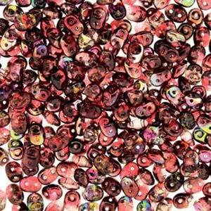 May include: A collection of small, oval-shaped beads in shades of red, brown, and iridescent colors. The beads have a glossy finish and are scattered across a white surface. These beads are suitable for jewelry making and crafting projects.