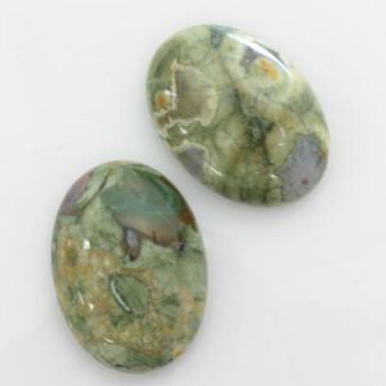 May include: Two oval-shaped green, brown, and white jasper stones. The stones have a mottled pattern.