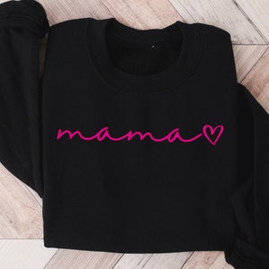 May include: Black sweatshirt with the word "mama" written in pink cursive with a pink heart.