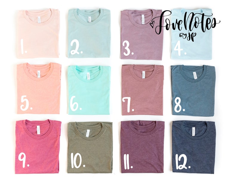 May include: Twelve folded t-shirts in various colors, including pink, blue, green, and purple. Each shirt is numbered 1 through 12.